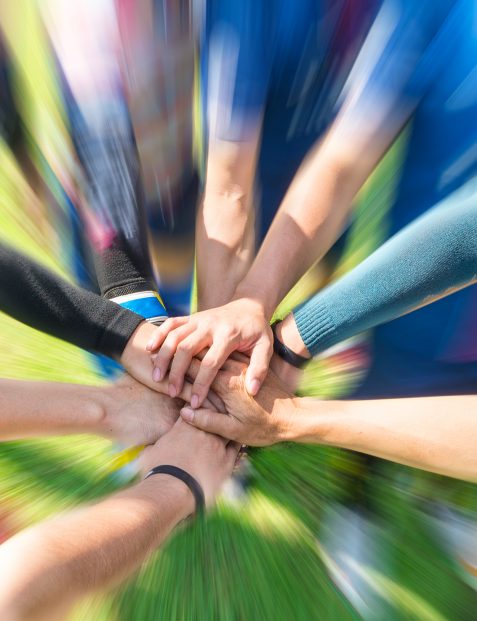 Blurred,Image,Of,Soccer,Players,Putting,Their,Hands,Together,Join